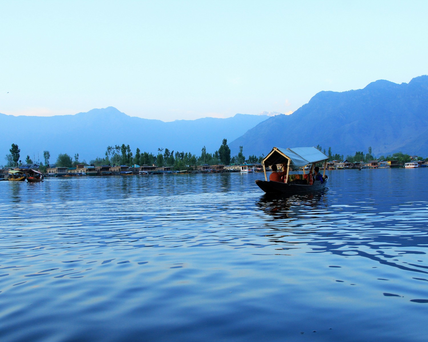 Dal Lake houseboats at sunrise with Himalayan backdrop